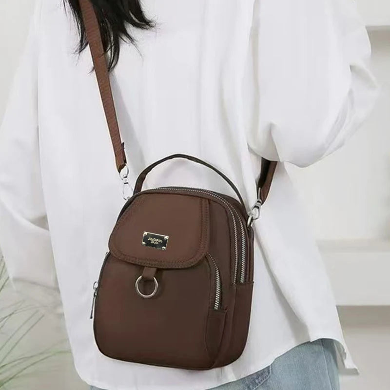 Neutral style backpack for men and women, suitable for travel and photography, multi-layered pocket, cross-body bag